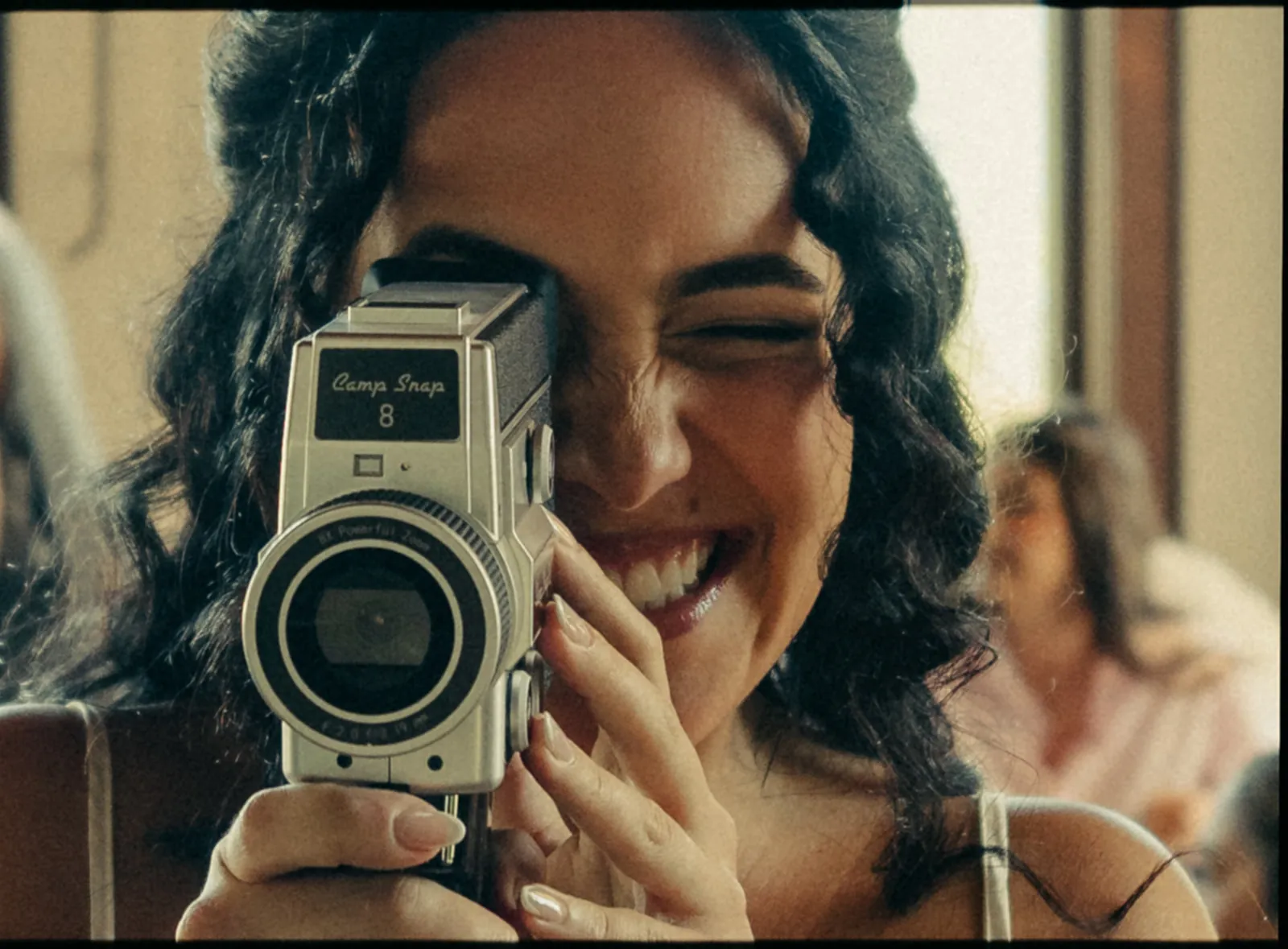 Bridesmaid laughing while filming with a vintage Camp Snap 8 camera during getting ready at a Catalina Island Casino wedding, shot on film
