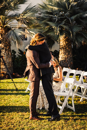father hugging bride during golden hour at san clemente beach wedding