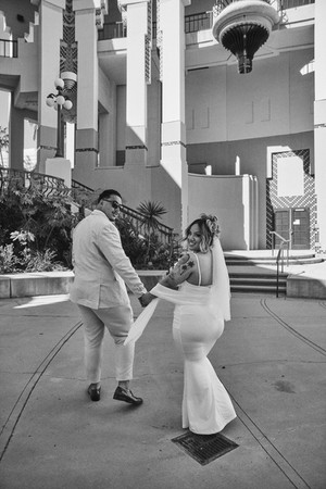 newlyweds walking together outside beverly hills city hall after courthouse ceremony
