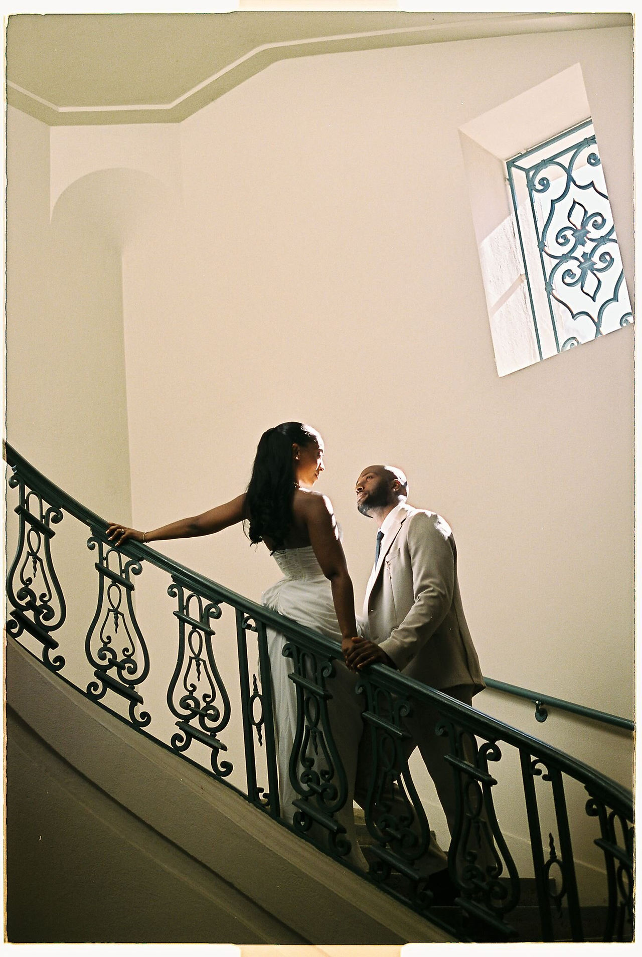 bride and groom on film at the staircase of pasadena city hall 