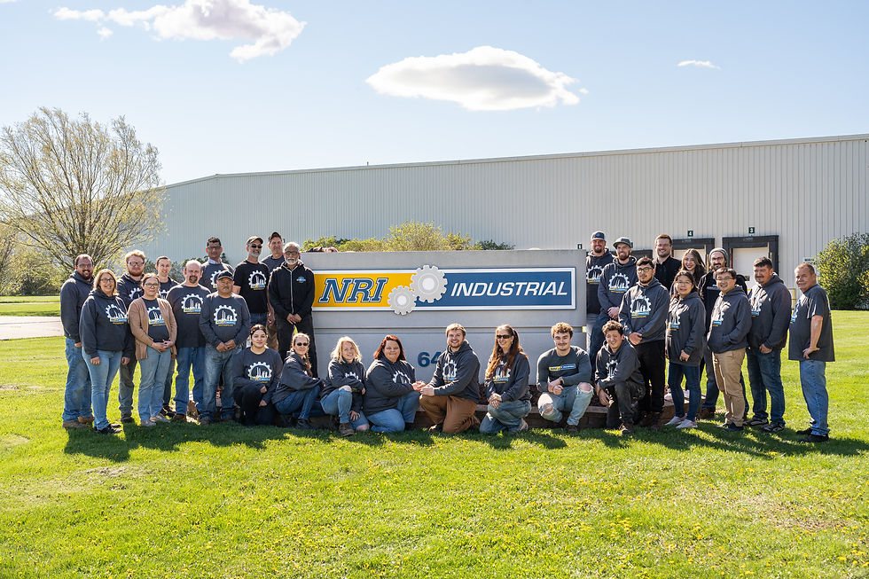 The NRI Industrial Sales team is posing in front of their facility, the official Welcome Reception sponsor for ANEXPO 2026.