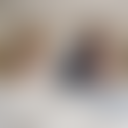 Middle-aged couple lying back to back in bed wearing pyjamas, not touching, representing separation while still living together.