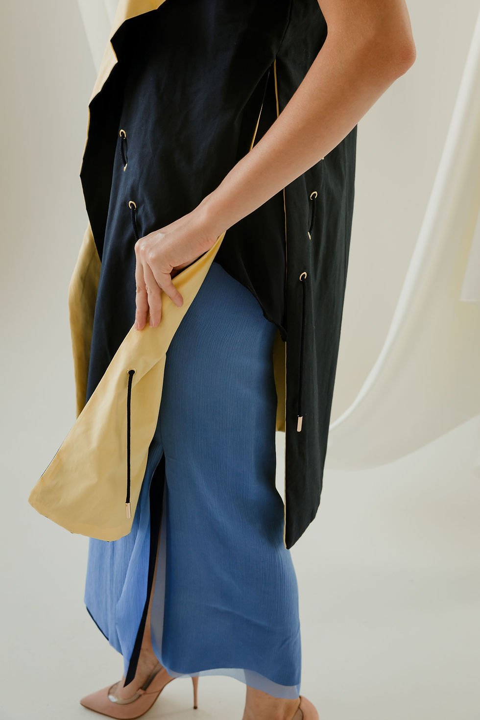 Thumbnail: Close up of the grommet and cable structure detailing that allows for the vest to be worn multiple ways.