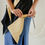 Thumbnail: Close up shot of a woman showing how to tighten the cables and scrunch up the lapels on the vest for a new look.