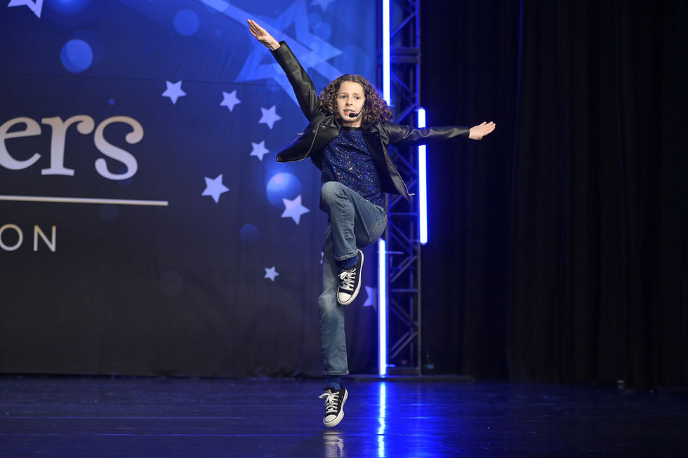 Young boy performing at musical theatre competition.