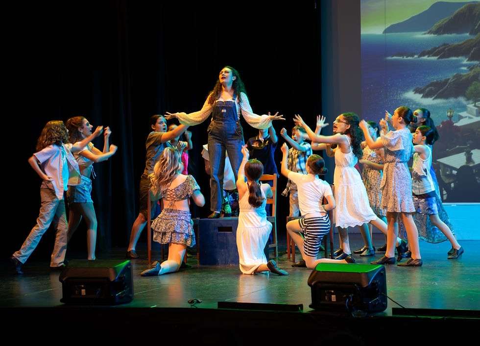 Young performers participating in a Mamma Mia production.