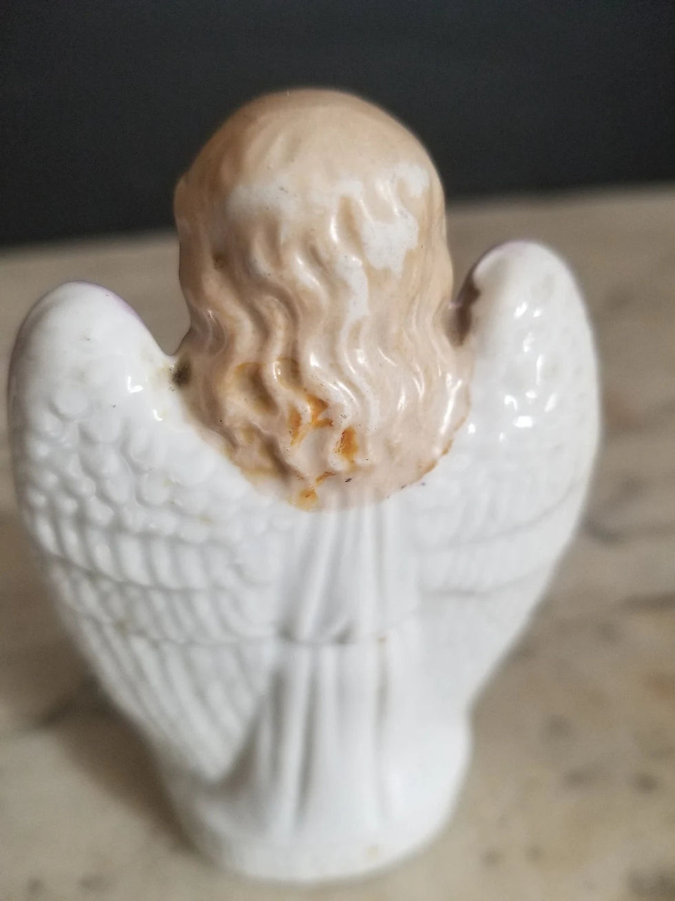 Thumbnail: Antique porcelain figurine Of an angel holding cross and flaming heart.