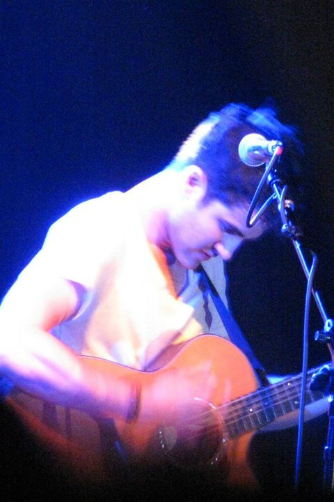 Darren strumming his guitar