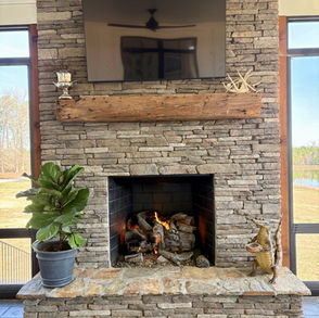 Stone fireplace with TV, burning fire, residential home builder