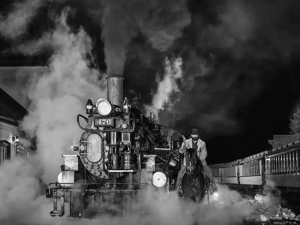 A photograph of the steam engine train and a cowboy on his horse by famous photographer David yarrow