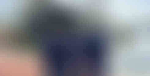 Students standing in front of a large ship