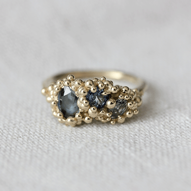 9ct yellow gold ring set with three sapphires in blue, green and teal. Handmade in Scotland.