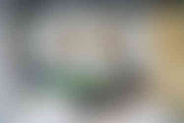 home gym with massage table visible and louvered wood paneling and workout equipment