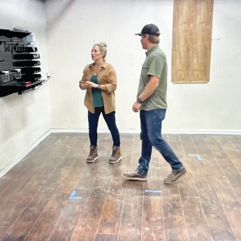 man and woman discussing layout of workshop