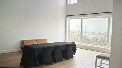 empty room with sofa, table with chairs, and big windows