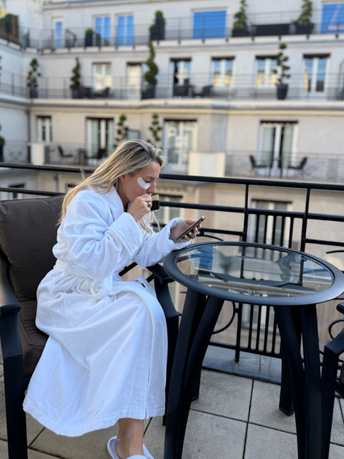 Brooke drinking coffee on our balcony at Prince de Galles - Marriott Property in Paris