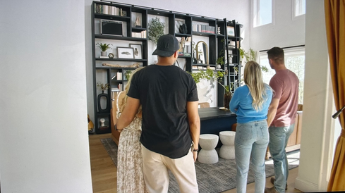 Four people looking into transformed dining space.