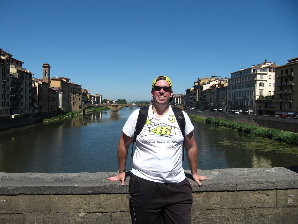 Man standing on bridge over river