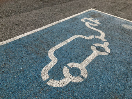 blue and white car painted symbol on parking spot tarmac