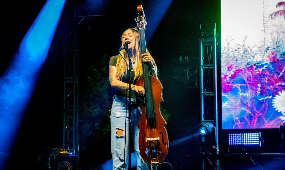 Emily Turner playing upright bass and singing on stage 
