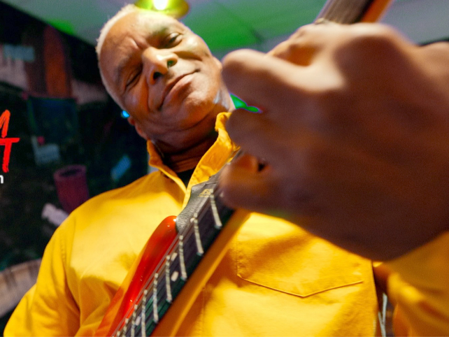 William dressed in yellow happy to play his guitar during the "Come Back Please" song