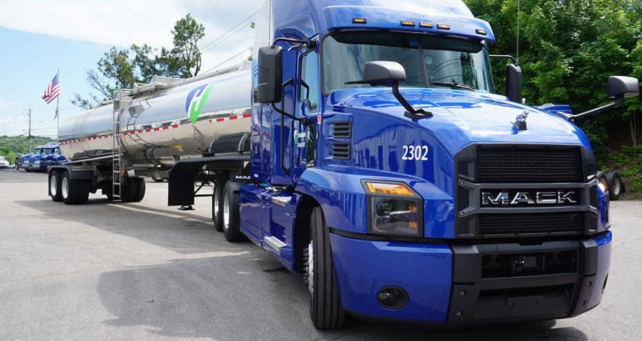 Blue Mack semi-truck 2302 with a silver tanker trailer