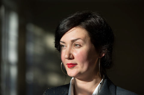 Portrait of Kaylinn Gilstrap, looking off to the side, wearing a black blazer and white shirt