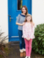 mother-daughter-standing-near-house.jpg