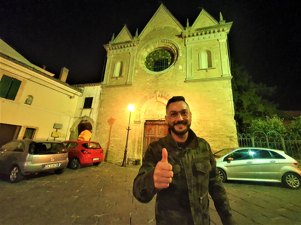 Il blogger Molise On The Road sorridente che si scatta un selfie con alle sue spalle la chiesa di San Antonio di Padova