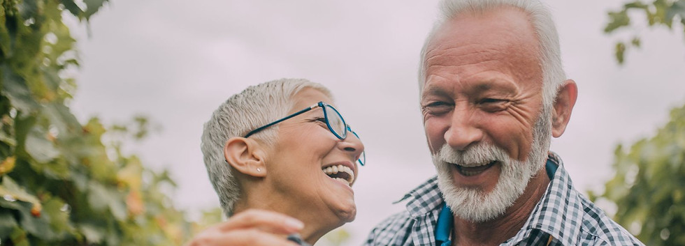 Retired couple smiling together at home, representing secure retirement planning