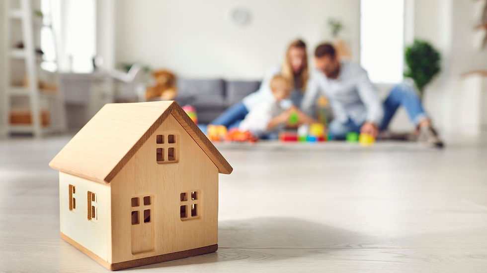 Young family playing together at home, representing the protection and peace of mind provided by life and home insurance