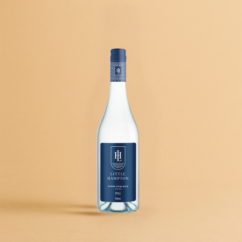 Little Hampton Still Water 750ml bottle, blue label and logo against beige background.