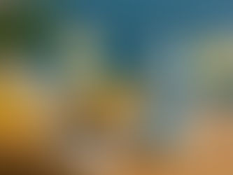 Acqua Sorrento sparkling water can placed on soft beach sand under a striped coastal umbrella, with turquoise water and a bright summer sky in the background.