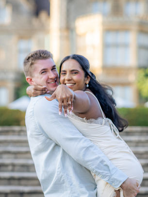 Engaged couple enjoying a romantic engagement photoshoot surrounded by greenery near Bristol