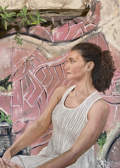 Self-portrait of the artist in white dress with pink graffiti wall in the background.