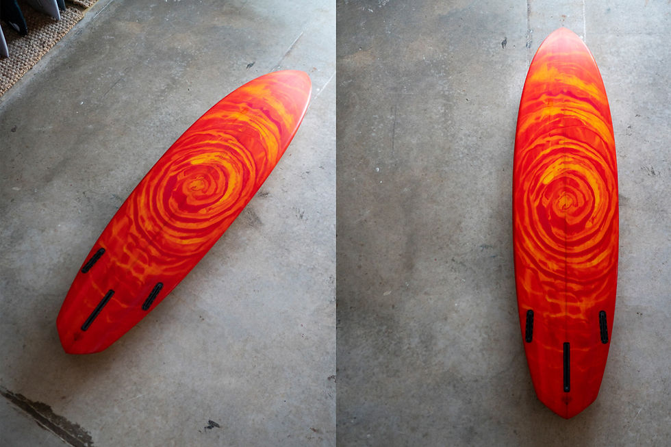 two angles of the bottom of an orange bonzer-inspired surfboard made by cord surfboards