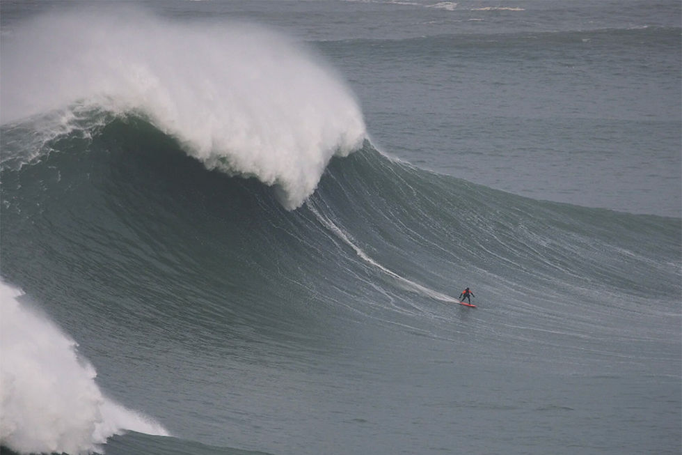 surfing ross clarke jones riding a giant wave at nazare in portugal