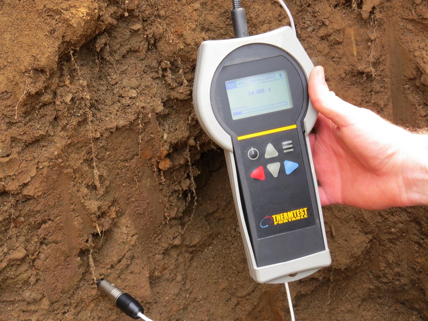 Hand-held instrument held against a soil face