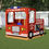 Thumbnail: Playground play fire engine truck with faux windows, lights, wheels, and grill. Includes steering wheel, deck, and seats