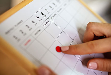 A calendar in a Tucson home showing the months of May and June, with a red dot highlighting Tuesday, June 6th—suggesting a scheduled weekly house cleaning or routine home maintenance. The pointing hand adds a personal touch to the planning moment.