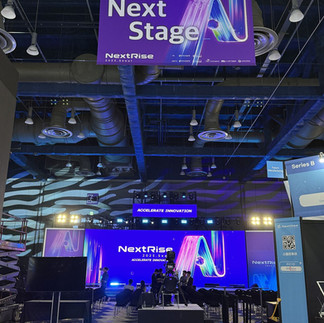 Main stage of NextRise 2025 at COEX Seoul, featuring large digital screens, keynote setup, and global startup branding