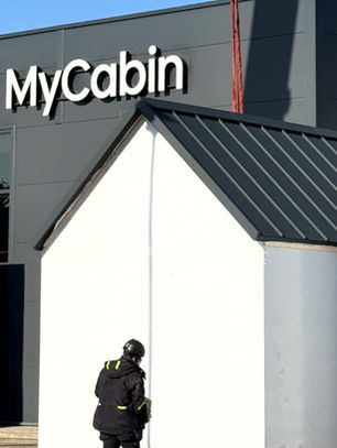MyCabin home in front of MyCabin factory