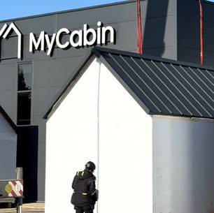 MyCabin home in front of MyCabin factory