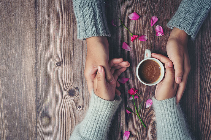 two-people-holding-cup-coffee-hands-with-love-warmth-wooden-table.jpg