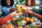 Multi Ethnic People Having Meal and Toasting Alcohol-Free Drinks.jpg