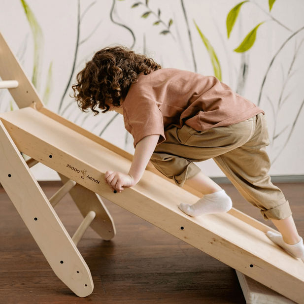 Child plays on climbing toy