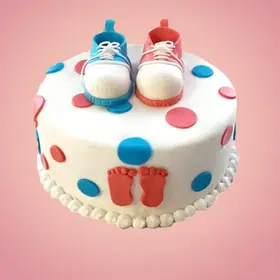 Adorably themed baby shower cake with celebratory decorations.