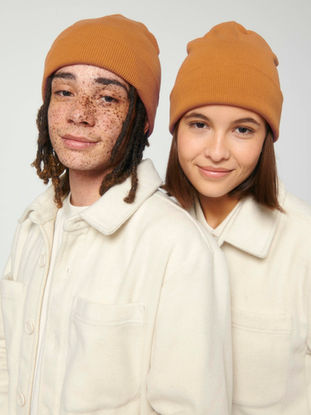 Zwei Personen tragen ockerfarbene Beanies, Modell Rib Beanie von Stanley/Stella – perfekt für personalisierte Drucke und Stickerei
