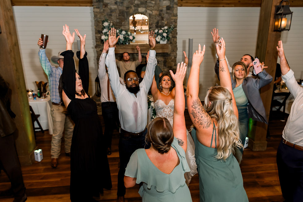 Everyone on the dance floor throws their hands up in the air