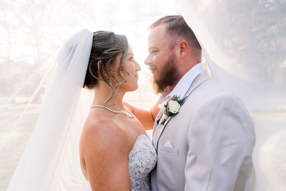 Bride and groom under veil at sunset. Old Homestead Farm